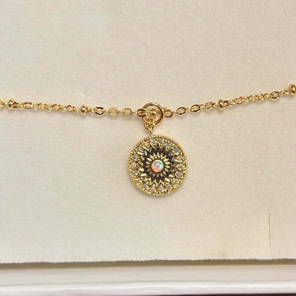 Petite, stunning pendant on 18” gold tone chain
